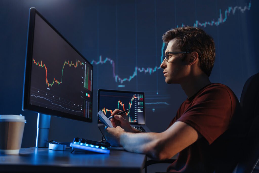 Man trader analyst at working table, analyzing financial chart, stock quotes, share prices, trading